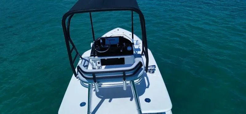 Slide: The Image of 2022 Contender 39 ST boat on clear blue water, featuring a sleek design and modern console. - 22