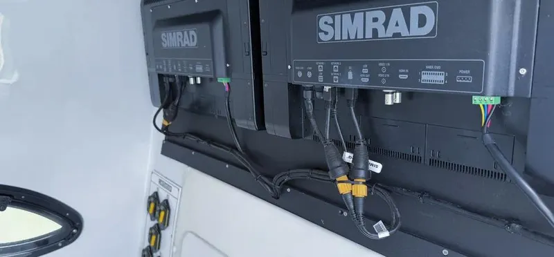 Slide: The Image of Simrad electronics on 2022 Contender 39 ST boat, showcasing advanced navigation systems. - 27
