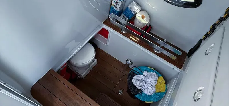 Slide: The Image of Interior of 2022 Contender 39 ST boat bathroom with toilet and storage. - 29