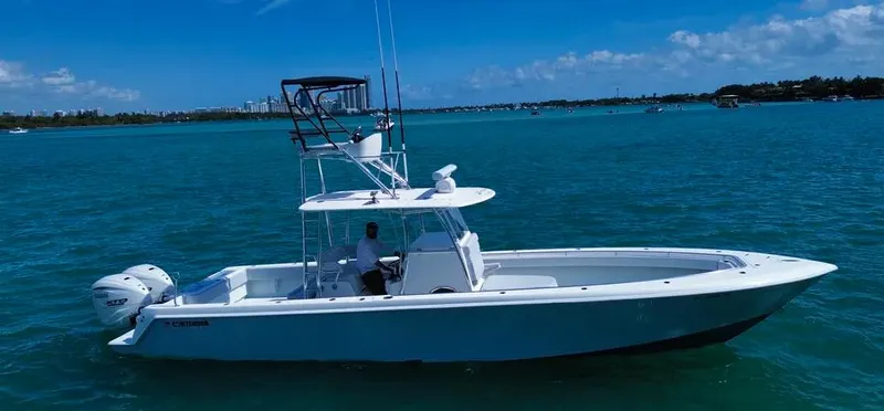 Slide: The Image of 2022 Contender 39 ST boat on clear blue water under a sunny sky. - 3
