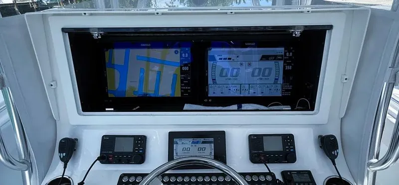 Slide: The Image of Control panel of a 2022 Contender 39 ST boat with advanced navigation displays. - 31