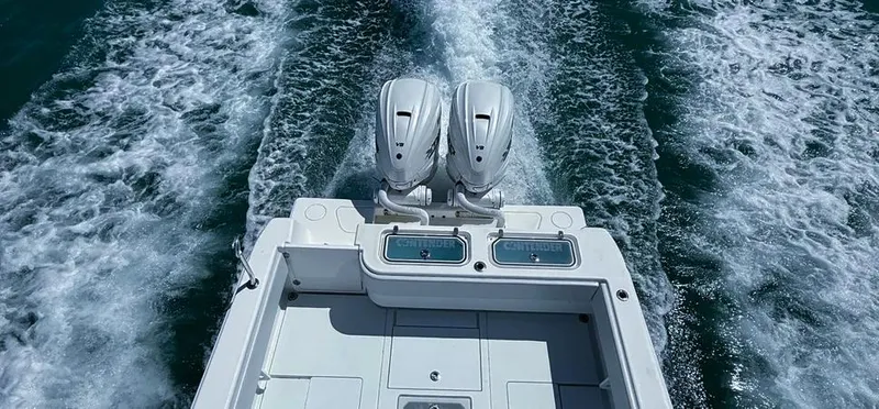 Slide: The Image of 2022 Contender 39 ST boat with dual engines cruising on open water. - 33