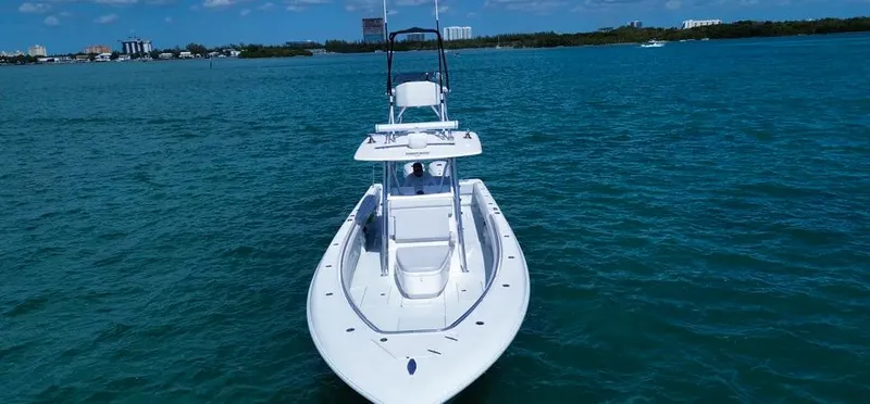 Slide: The Image of 2022 Contender 39 ST boat on clear blue water, showcasing sleek design and spacious deck. - 34