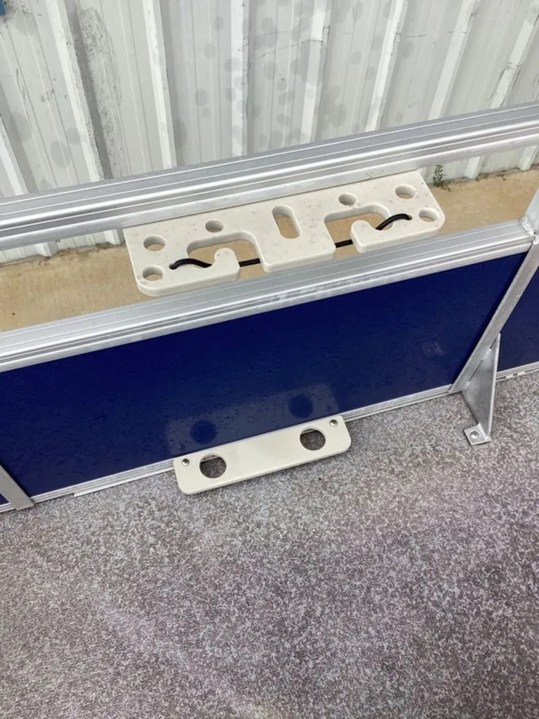 Slide: The Image of Sun Tracker 22DLX 2016 boat details with blue paneling and brackets. - 17