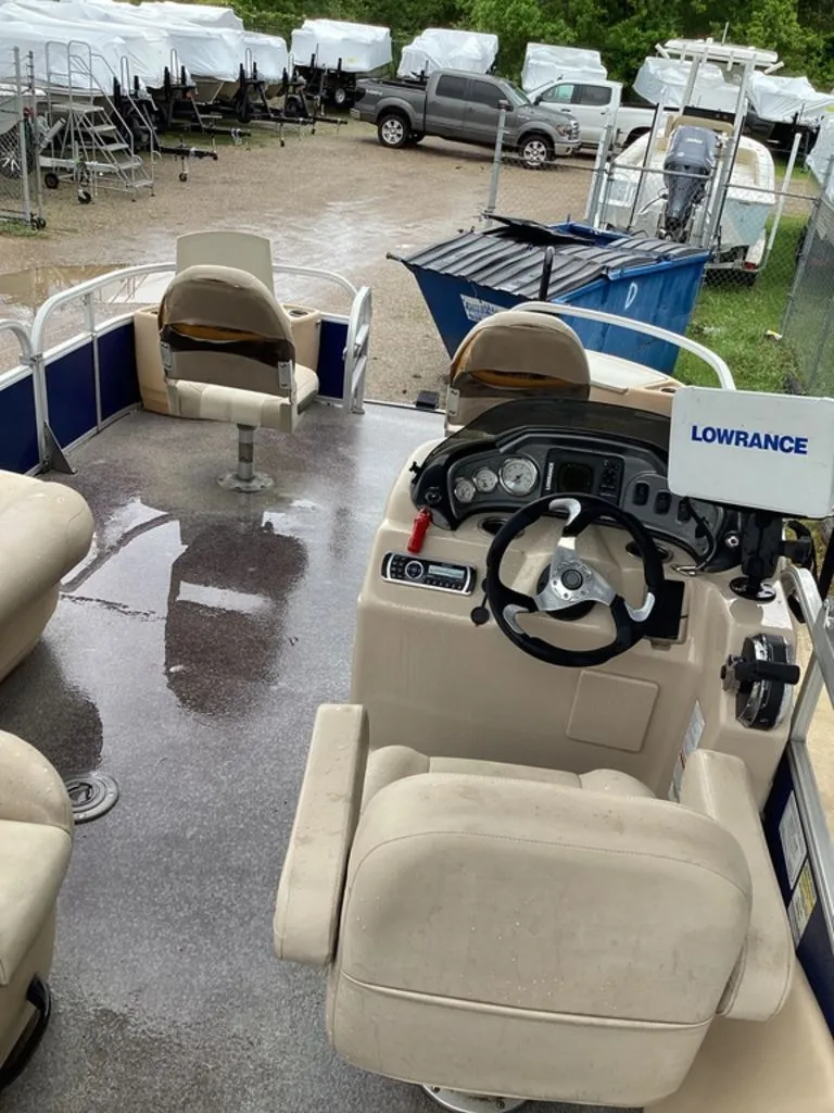 Slide: The Image of Interior view of a 2016 Sun Tracker 22DLX pontoon boat with helm console. - 23
