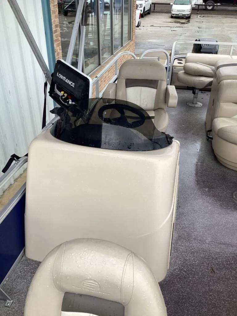Slide: The Image of Interior of a 2016 Sun Tracker 22DLX pontoon boat with steering console. - 25