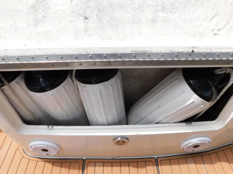 Slide: The Image of 1997 Sea Ray 330 Sundancer boat fenders stored in compartment. - 16