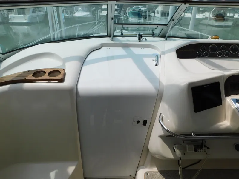 Slide: The Image of 1997 Sea Ray 330 Sundancer helm with cup holders and control panel. - 42