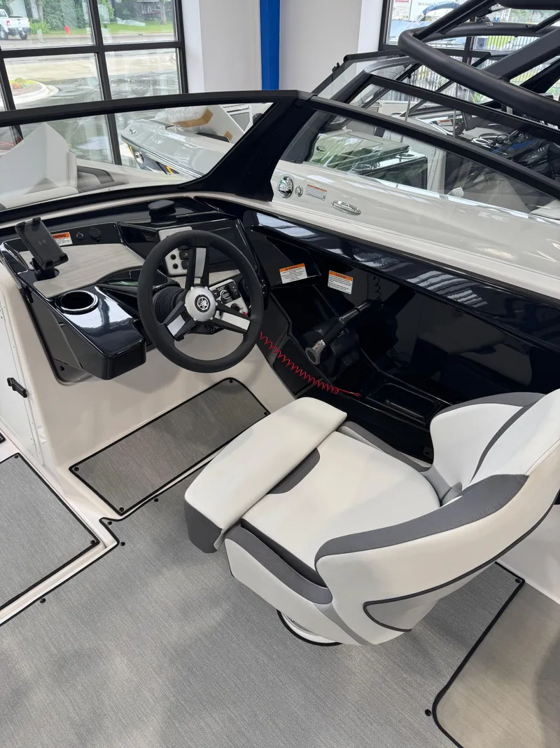 Slide: The Image of 2025 Yamaha Boats SX220 cockpit with steering wheel and captain's chair. - 5