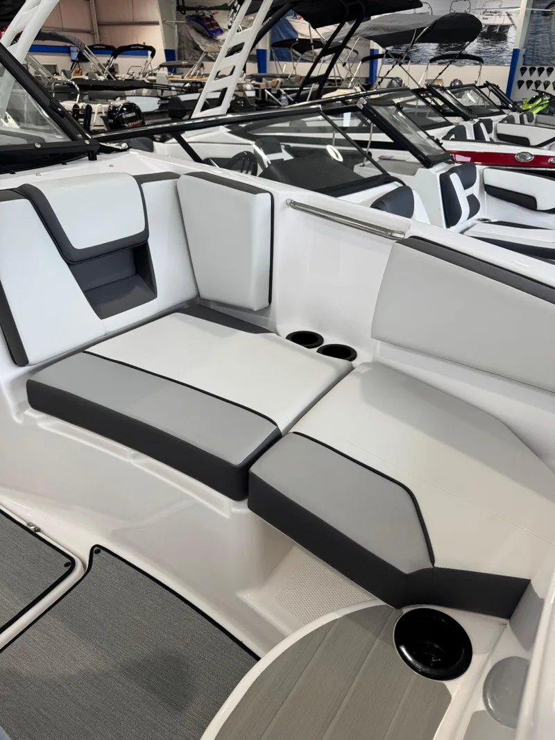 Slide: The Image of 2025 Yamaha Boats SX220 interior seating with sleek, modern design and cup holders. - 9