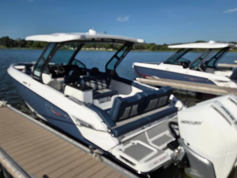 Slide: The Image of 2025 Monterey Elite 30 OB boat docked on a sunny day. - 2