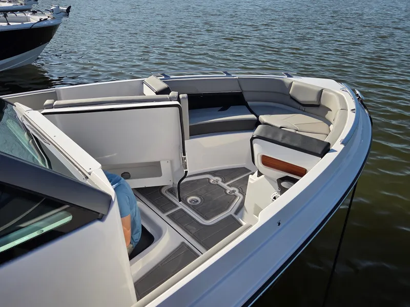 Slide: The Image of 2025 Monterey Elite 30 OB boat interior with spacious seating on calm water. - 3