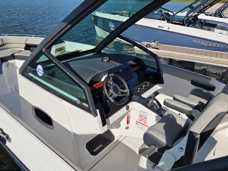 Slide: The Image of 2025 Monterey Elite 30 OB boat interior with modern dashboard and seating. - 4