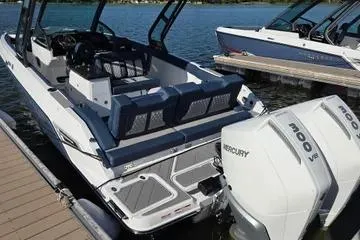 Slide: The Image of 2025 Monterey Elite 30 OB boat docked with dual Mercury engines. - 6