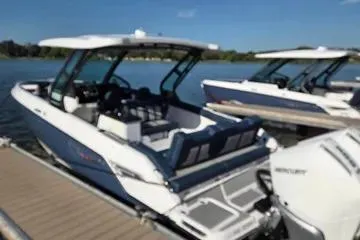 Slide: The Image of 2025 Monterey Elite 30 OB boat docked on a sunny day. - 7