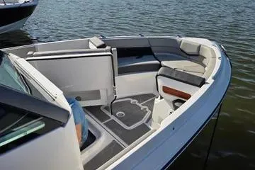 Slide: The Image of 2025 Monterey Elite 30 OB boat interior with seating, on calm water. - 8