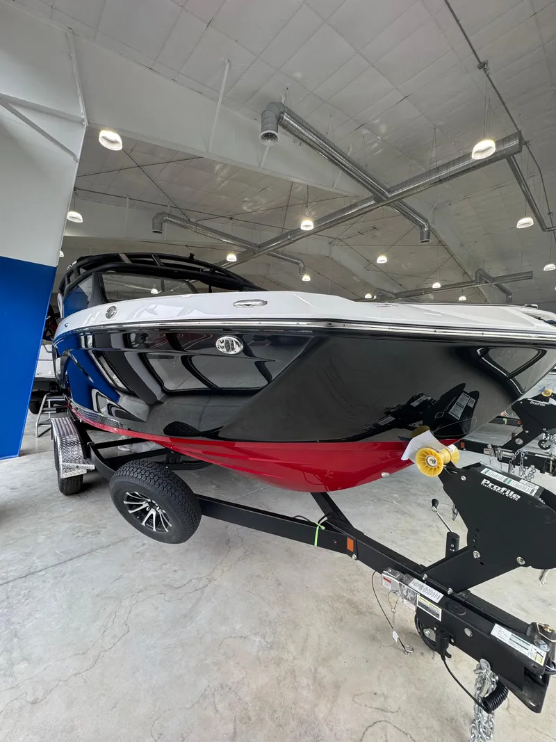 The Image of 2025 Yamaha Boats 222SD on trailer in showroom, showcasing sleek design and vibrant colors. - 0