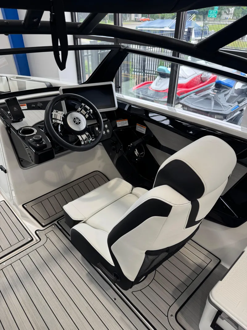 Slide: The Image of 2025 Yamaha Boats 222SD cockpit with modern steering and sleek white seating. - 7