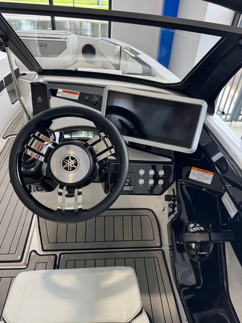 Slide: The Image of 2025 Yamaha Boats 222SD dashboard with steering wheel and touchscreen display. - 8