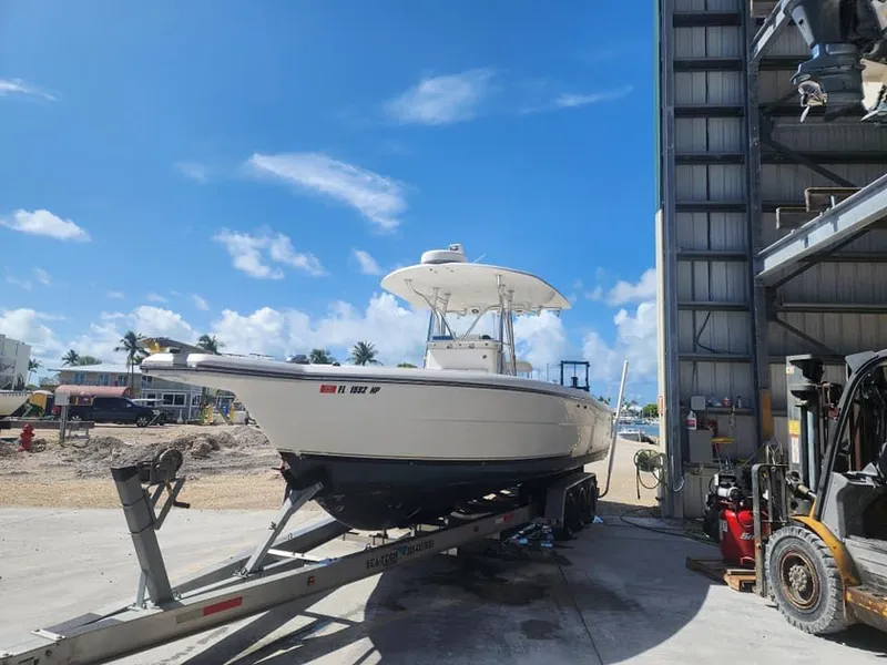 Slide: The Image of 2006 Stamas 290 Tarpon boat on trailer under clear blue sky. - 5