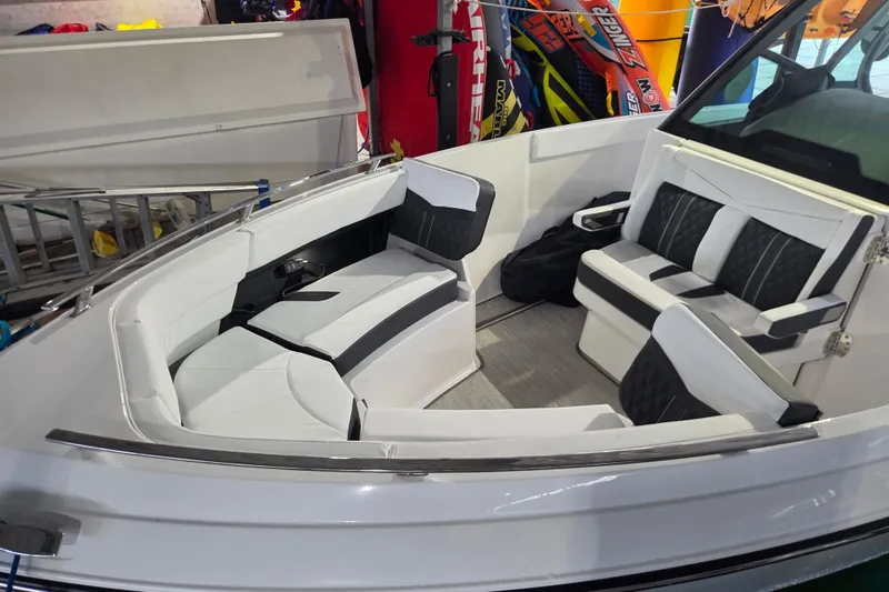 Slide: The Image of 2026 Monterey Elite 27 OB boat interior with white and black seating, showcasing modern design. - 17