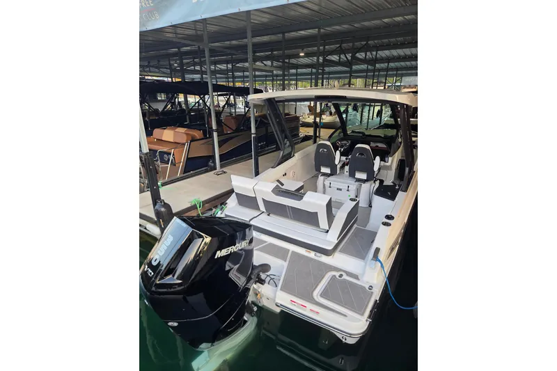 Slide: The Image of 2026 Monterey Elite 27 OB boat docked with Mercury outboard engine. - 18
