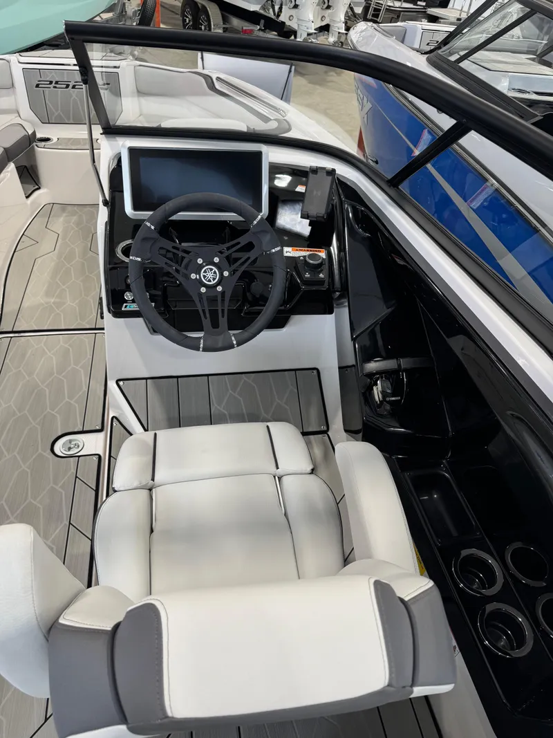Slide: The Image of 2025 Yamaha Boats 252XE cockpit with steering wheel and modern dashboard. - 11