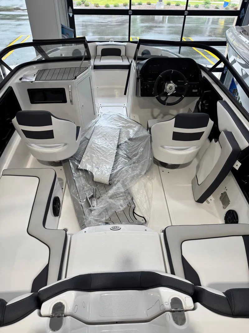 Slide: The Image of 2025 Yamaha Boats 195S interior with seating and steering wheel, showcasing modern design. - 2