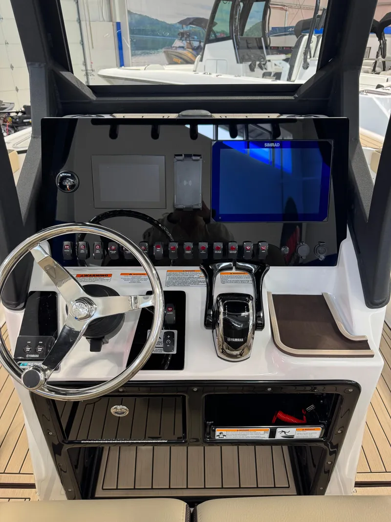 Slide: The Image of 2025 Yamaha Boats 255 FSH Sport E dashboard with steering wheel and control panel. - 11