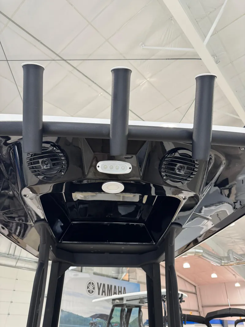 Slide: The Image of 2025 Yamaha Boats 255 FSH Sport E, interior view with speakers and rod holders. - 12