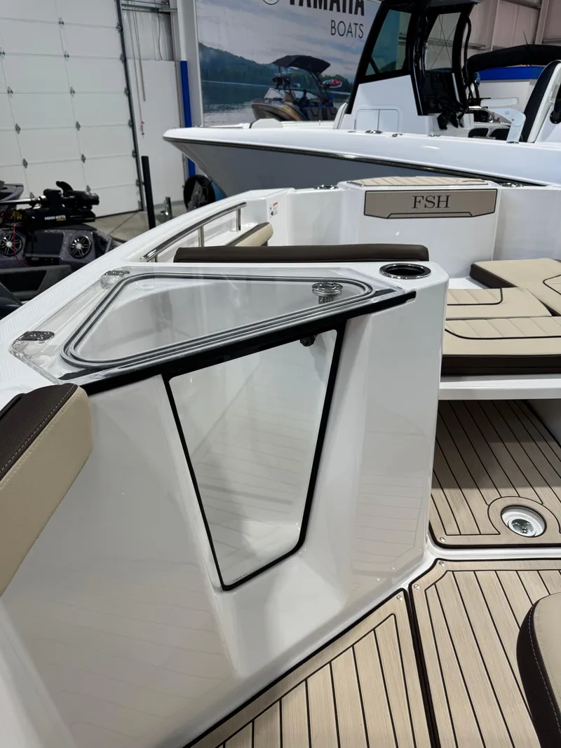 Slide: The Image of 2025 Yamaha Boats 255 FSH Sport E interior with seating and storage features. - 15
