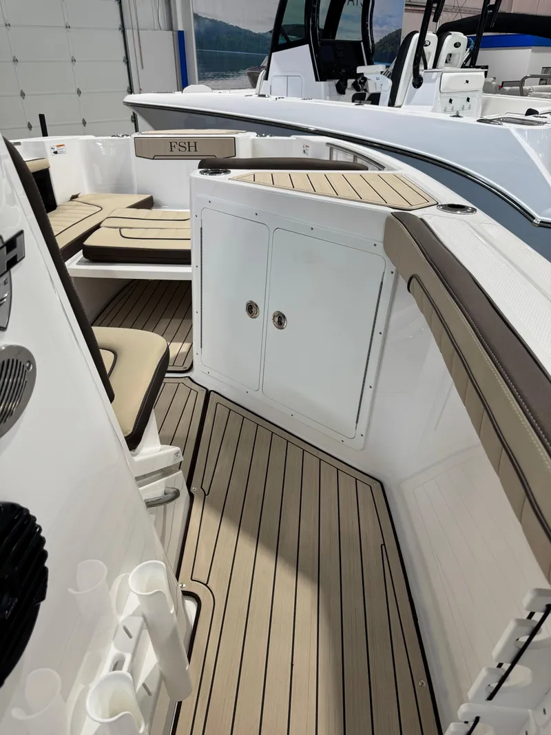 Slide: The Image of 2025 Yamaha Boats 255 FSH Sport E interior with seating and storage compartments. - 16