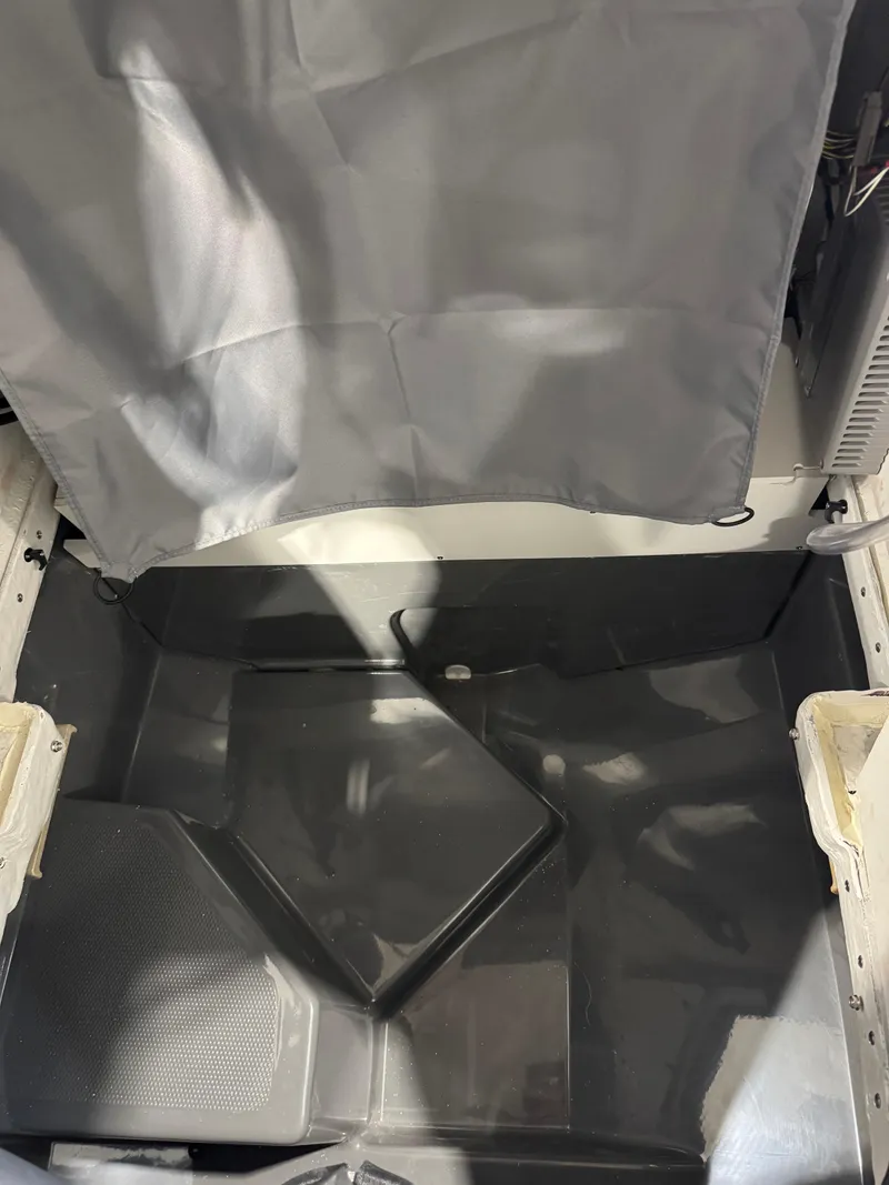 Slide: The Image of 2025 Yamaha Boats 255 FSH Sport E interior detail, showcasing storage compartment. - 19