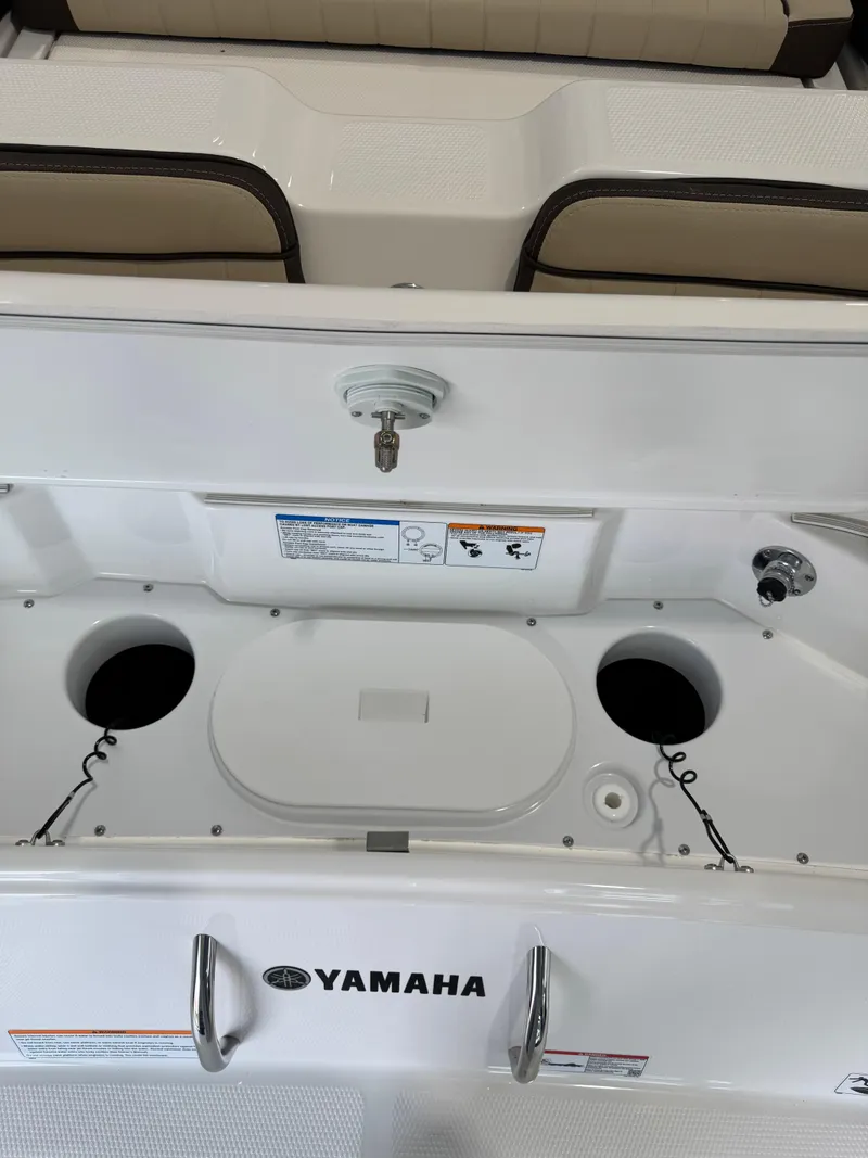 Slide: The Image of 2025 Yamaha Boats 255 FSH Sport E interior with storage compartments and seating. - 2