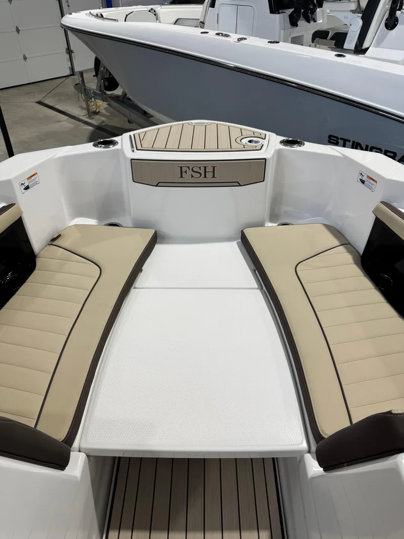 Slide: The Image of 2025 Yamaha Boats 255 FSH Sport E interior with beige seating and deck. - 20