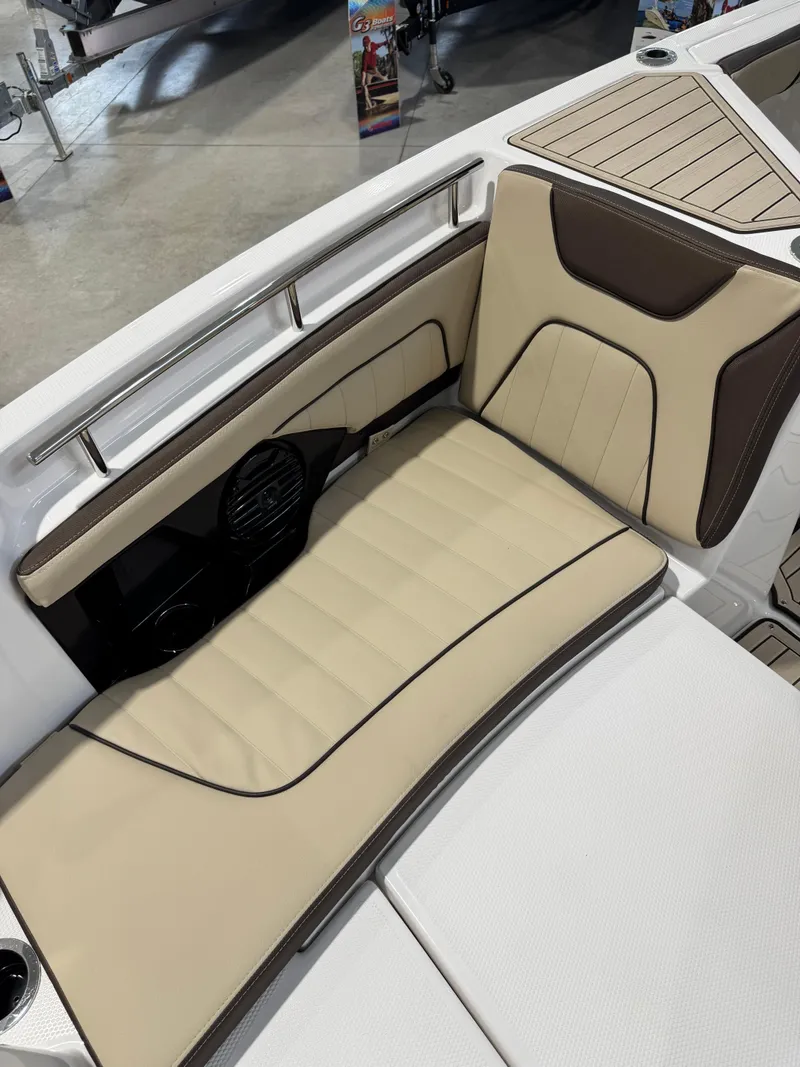 Slide: The Image of 2025 Yamaha Boats 255 FSH Sport E interior seating with beige and brown upholstery. - 21