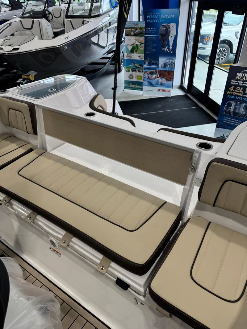 Slide: The Image of 2025 Yamaha Boats 255 FSH Sport E interior with beige seating and modern design. - 8