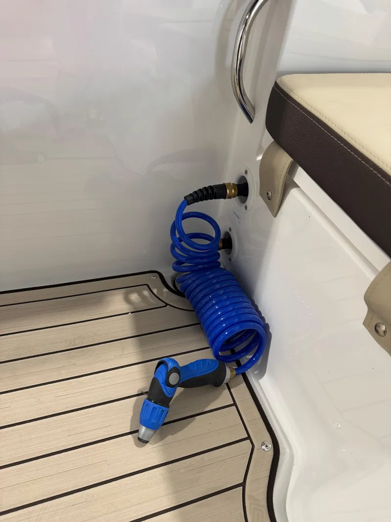 Slide: The Image of Coiled blue hose on 2025 Yamaha Boats 255 FSH Sport E deck. - 9