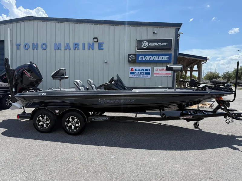 Slide: The Image of 2026 Phoenix 721 ZXL boat at Toho Marine dealership, featuring dual motors and sleek design. - 1