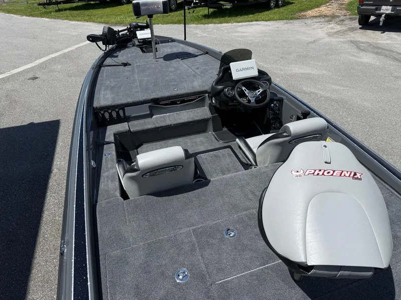 Slide: The Image of 2026 Phoenix 721 ZXL boat interior with Garmin system, gray seating, and spacious deck. - 12
