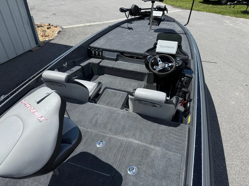Slide: The Image of 2026 Phoenix 721 ZXL boat interior with Garmin system, gray seating, and spacious deck. - 13