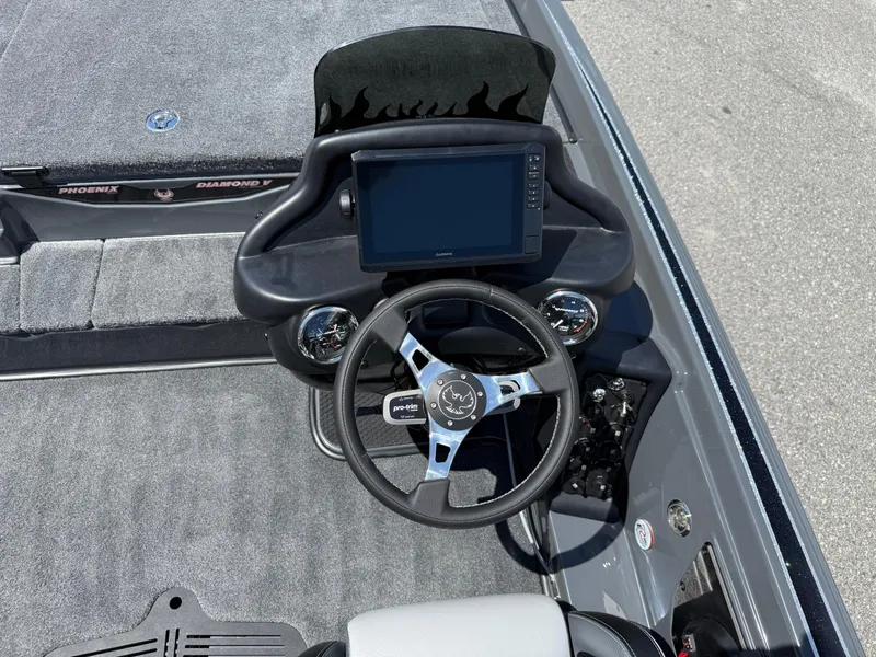 Slide: The Image of 2026 Phoenix 721 ZXL boat dashboard with steering wheel and digital display. - 14
