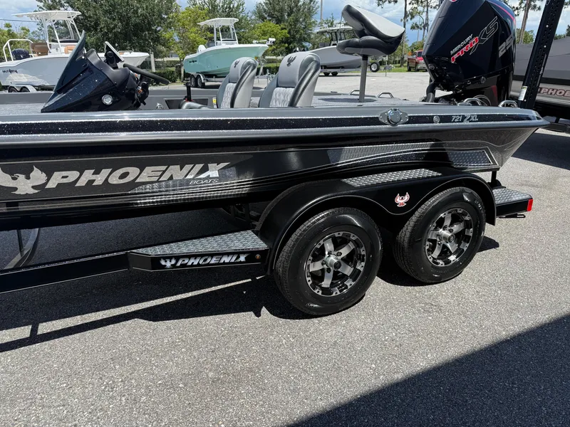 Slide: The Image of 2026 Phoenix 721 ZXL boat on trailer, featuring sleek design and dual wheels. - 5