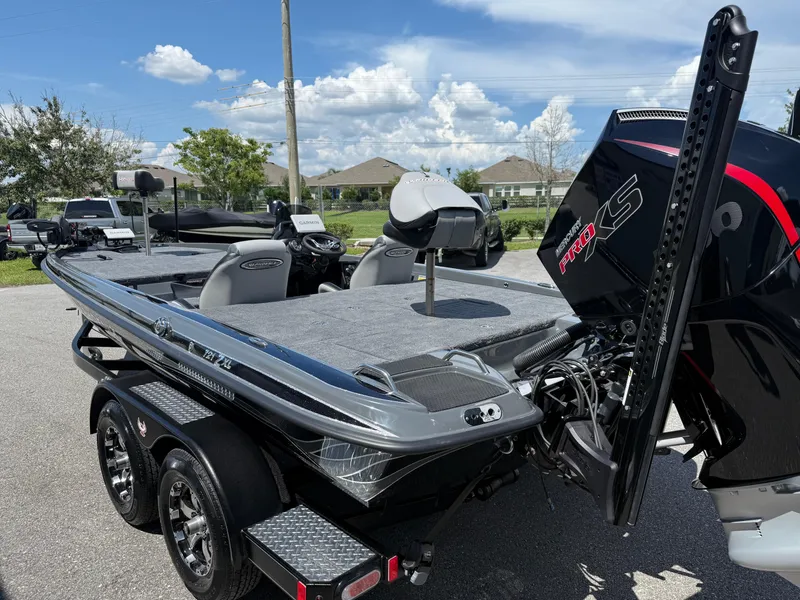 Slide: The Image of 2026 Phoenix 721 ZXL bass boat with powerful engine and sleek design on a sunny day. - 6