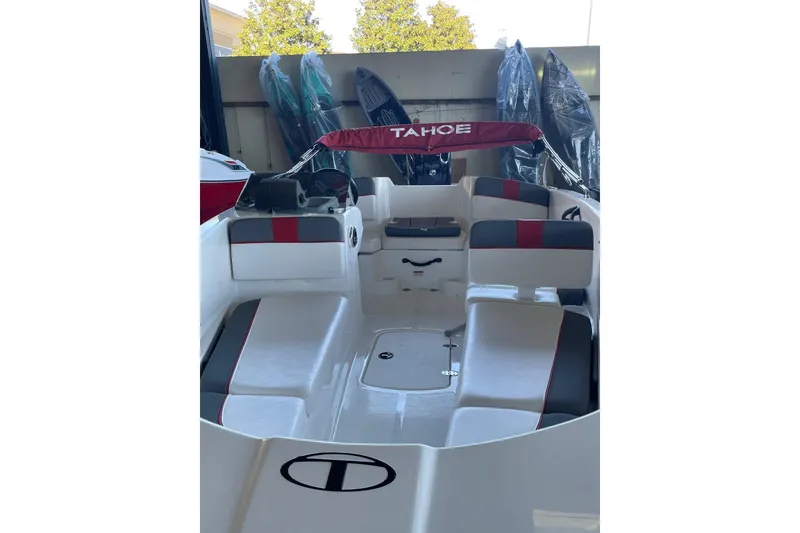 Slide: The Image of 2025 Tahoe T16 boat interior with red and gray seating, under a canopy. - 2