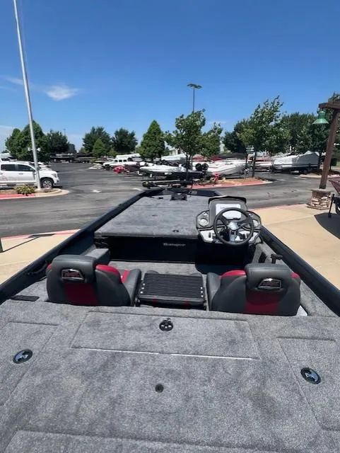 Slide: The Image of 2025 Ranger RT188 boat interior with steering wheel, seats, and spacious deck in outdoor setting. - 5