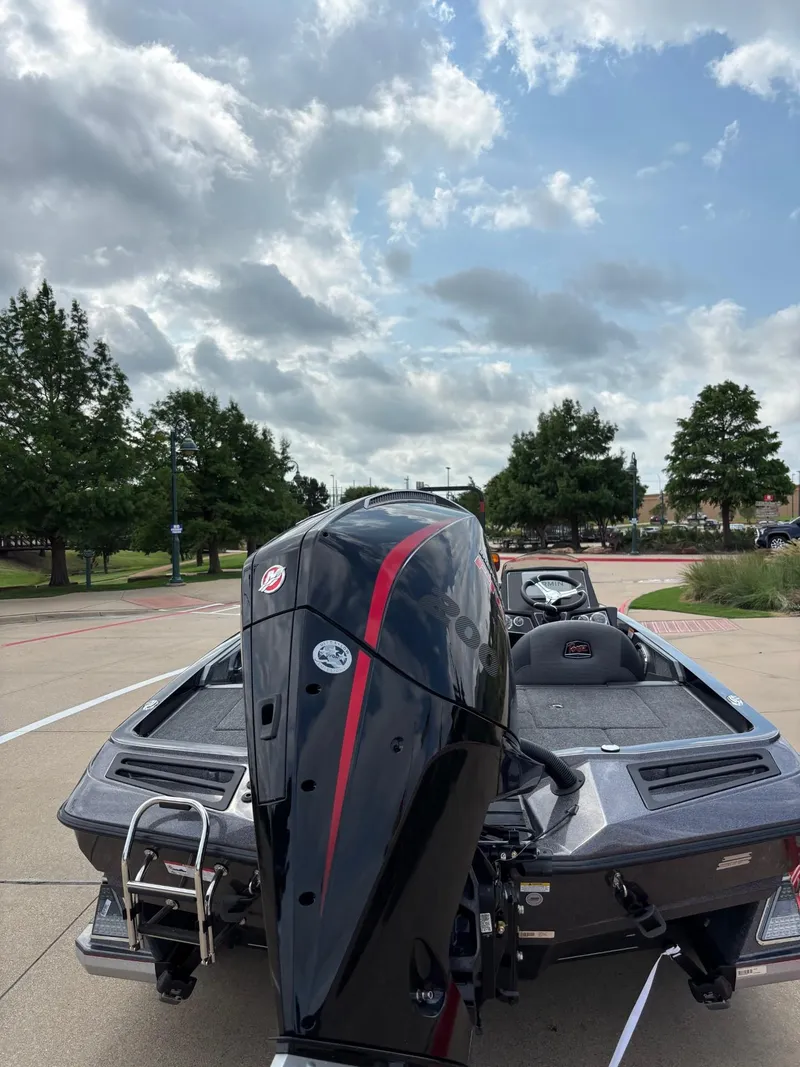 Slide: The Image of 2025 Ranger Z518 Cup-Equipped boat on trailer, parked outdoors under clear blue sky. - 3
