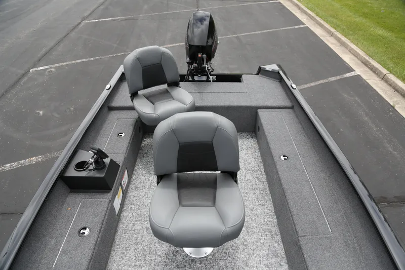 Slide: The Image of 2025 Tracker Super Guide V-16 T boat interior with two gray seats and motor. - 2