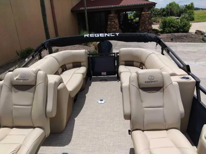 Slide: The Image of 2025 Regency 250 LE3 pontoon boat with luxurious beige seating and spacious interior. - 3