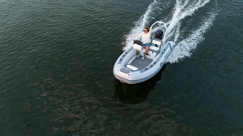 Slide: The Image of 2025 Highfield Classic 400 boat cruising on open water, aerial view. - 5